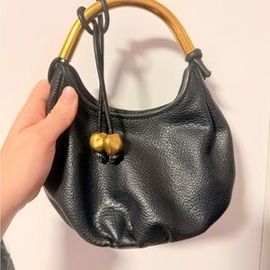 Elegant Black Leather Handbag with Gold Accents